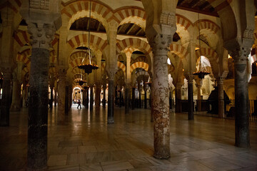 Beige and red arches and marble columns in mosque