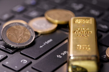 money coins on laptop computer