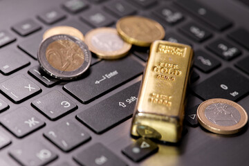 money coins on laptop computer