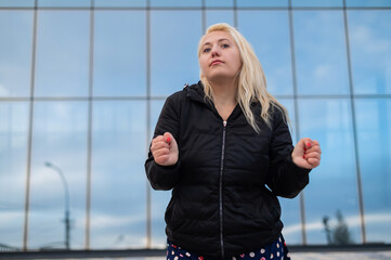 Emotional deaf and dumb woman talking sign language outdoors.