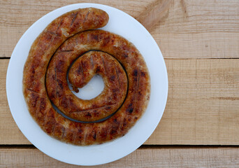 Homemade grilled sausage on the white plate