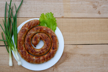 Homemade grilled sausage on the white plate