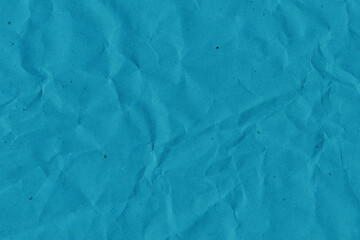 Blue vintage and old looking crumpled paper background. Retro cardboard texture. Grunge paper for drawing. Ancient book page. Present wrapping.