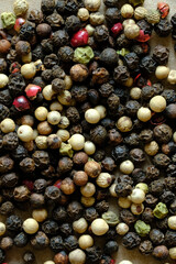 Macro image of Different color mixed peppercorns. Concept of food ingredients and spices. Copy space and top view.