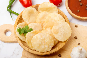 Indian dish luchi on a white table
