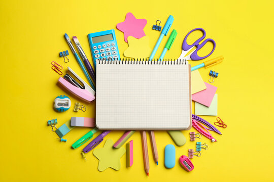 Blank notebook and school stationery on yellow background, flat lay with space for text. Back to school