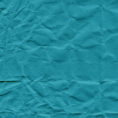 Blue vintage and old looking crumpled paper background. Retro cardboard texture. Grunge paper for drawing. Ancient book page. Present wrapping.