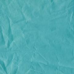 Blue vintage and old looking crumpled paper background. Retro cardboard texture. Grunge paper for drawing. Ancient book page. Present wrapping.