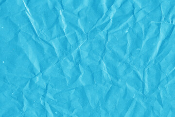 Blue vintage and old looking crumpled paper background. Retro cardboard texture. Grunge paper for drawing. Ancient book page. Present wrapping.