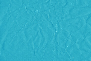 Blue vintage and old looking crumpled paper background. Retro cardboard texture. Grunge paper for drawing. Ancient book page. Present wrapping.