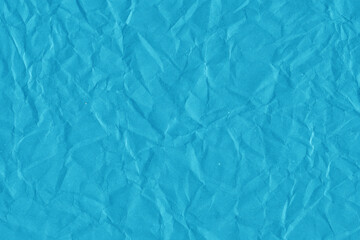 Blue vintage and old looking crumpled paper background. Retro cardboard texture. Grunge paper for drawing. Ancient book page. Present wrapping.