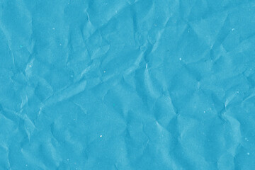 Blue vintage and old looking crumpled paper background. Retro cardboard texture. Grunge paper for drawing. Ancient book page. Present wrapping.