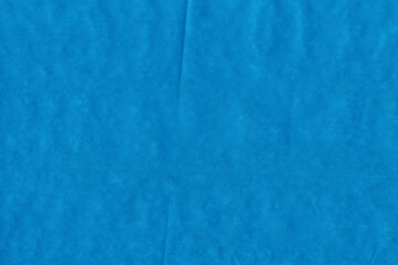 Blue vintage and old looking crumpled paper background. Retro cardboard texture. Grunge paper for drawing. Ancient book page. Present wrapping.