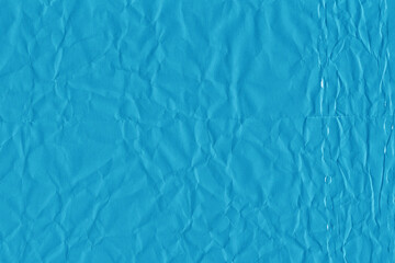 Blue vintage and old looking crumpled paper background. Retro cardboard texture. Grunge paper for drawing. Ancient book page. Present wrapping.