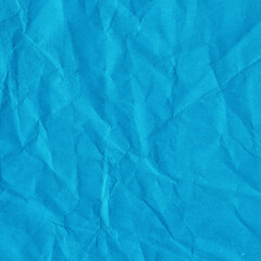 Blue vintage and old looking crumpled paper background. Retro cardboard texture. Grunge paper for drawing. Ancient book page. Present wrapping.