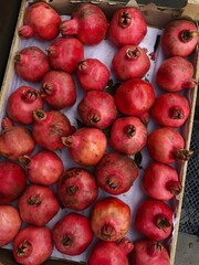 Ripe juicy pomegranates on the market macro