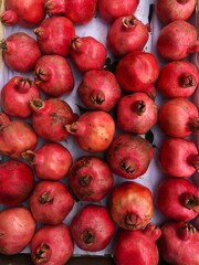 Ripe juicy pomegranates on the market macro