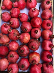 Ripe juicy pomegranates on the market macro