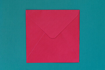 Red envelope to send letters on blue background. Concept of postal development, written...