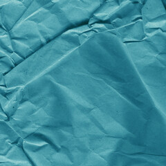 Blue vintage and old looking crumpled paper background. Retro cardboard texture. Grunge paper for drawing. Ancient book page. Present wrapping.