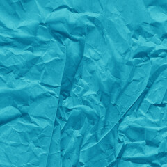 Blue vintage and old looking crumpled paper background. Retro cardboard texture. Grunge paper for drawing. Ancient book page. Present wrapping.