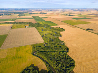Aerial View of Winding River, Trees and Farm Fields on Summer Day in North Dakota.