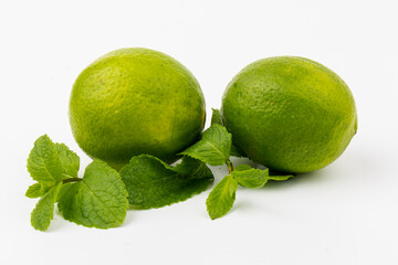 Lime with mint leaves isolated on white background.