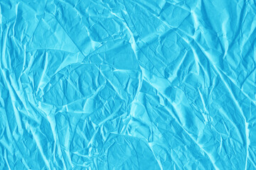 Blue vintage and old looking crumpled paper background. Retro cardboard texture. Grunge paper for drawing. Ancient book page. Present wrapping.