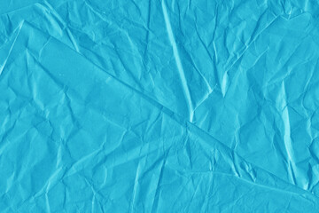 Blue vintage and old looking crumpled paper background. Retro cardboard texture. Grunge paper for drawing. Ancient book page. Present wrapping.