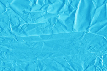 Blue vintage and old looking crumpled paper background. Retro cardboard texture. Grunge paper for drawing. Ancient book page. Present wrapping.