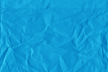 Blue vintage and old looking crumpled paper background. Retro cardboard texture. Grunge paper for drawing. Ancient book page. Present wrapping.