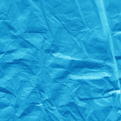 Obraz premium Blue vintage and old looking crumpled paper background. Retro cardboard texture. Grunge paper for drawing. Ancient book page. Present wrapping.