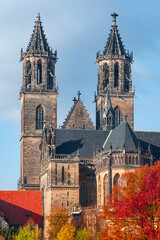 Fototapeta premium Magnificent Cathedral in historical and shopping downtown of Magdeburg, old town, Elbe river at early golden Autumn, Magdeburg, Germany.