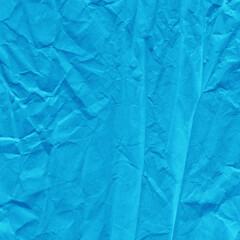 Blue vintage and old looking crumpled paper background. Retro cardboard texture. Grunge paper for drawing. Ancient book page. Present wrapping.