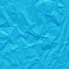 Blue vintage and old looking crumpled paper background. Retro cardboard texture. Grunge paper for drawing. Ancient book page. Present wrapping.