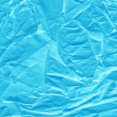 Blue vintage and old looking crumpled paper background. Retro cardboard texture. Grunge paper for drawing. Ancient book page. Present wrapping.