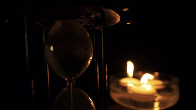 Hourglass and floating candles as Time Lapse , candle lights are flickering then extinguishing. This is the faster version. You can find slower and longer version of the same clip at my portfolio.