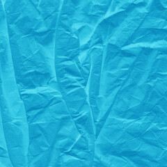 Blue vintage and old looking crumpled paper background. Retro cardboard texture. Grunge paper for drawing. Ancient book page. Present wrapping.