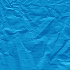 Blue vintage and old looking crumpled paper background. Retro cardboard texture. Grunge paper for drawing. Ancient book page. Present wrapping.