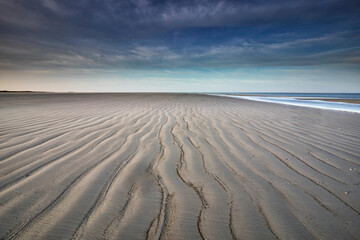 Fototapeta na wymiar wave sand textures on beach