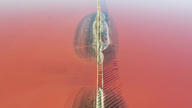 Aerial video flying over pink salt lake water from drone. Genichesk, Ukraine. 4k UHD footage