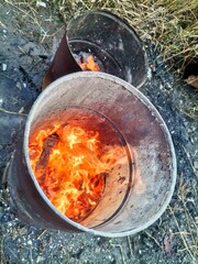Fire in an old barrel on the street.