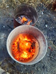 Fire in an old barrel on the street.