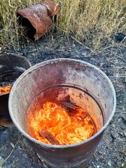 Fire in an old barrel on the street.