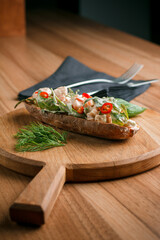 Italian tomato bruschetta with chopped vegetables, herbs and butter on toast or toasted ciabatta bread.