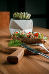 Italian tomato bruschetta with chopped vegetables, herbs and butter on toast or toasted ciabatta bread.