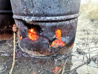 Fire in an old barrel on the street.