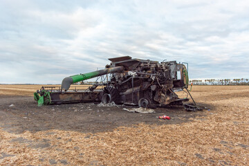 Back/Side View of Burnt Combine Harvester on Grain Field in Rural North Dakota, taken at Daytime...