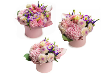 Pink and purple bouquet of flowers in a pink box isolated on white.