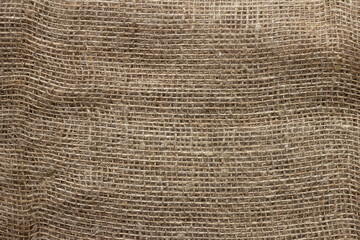 Texture of crumpled natural burlap close-up.